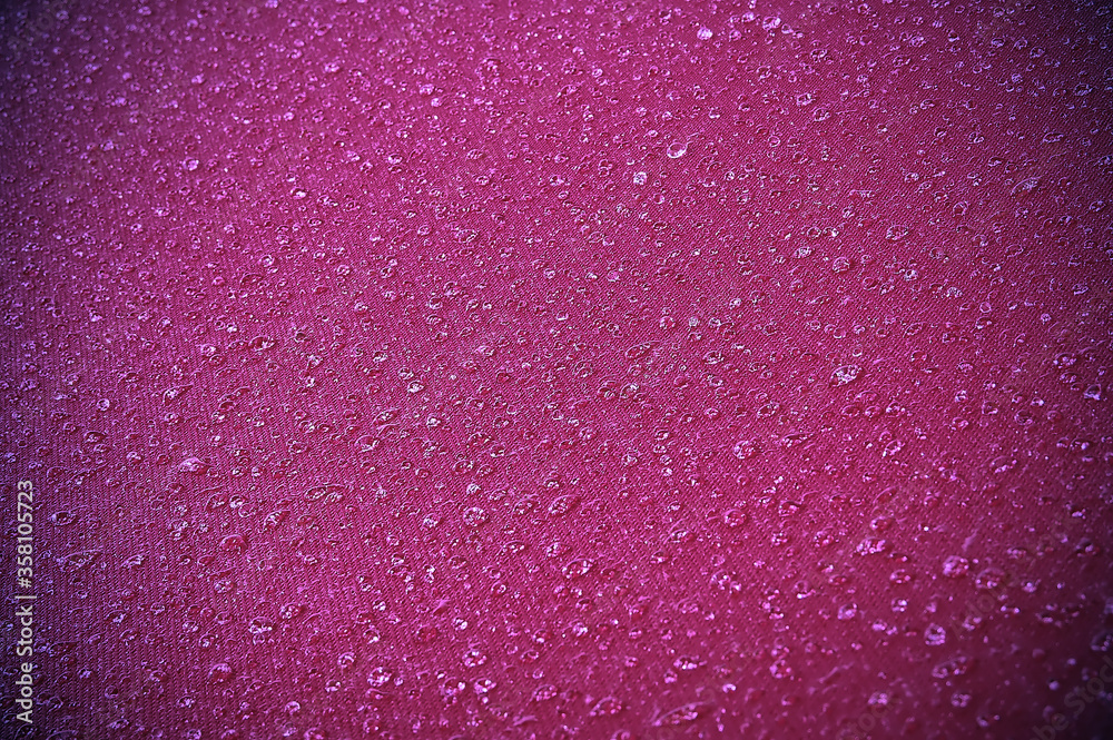 Water drops on purple textile after rain Water drops on purple textile after rain