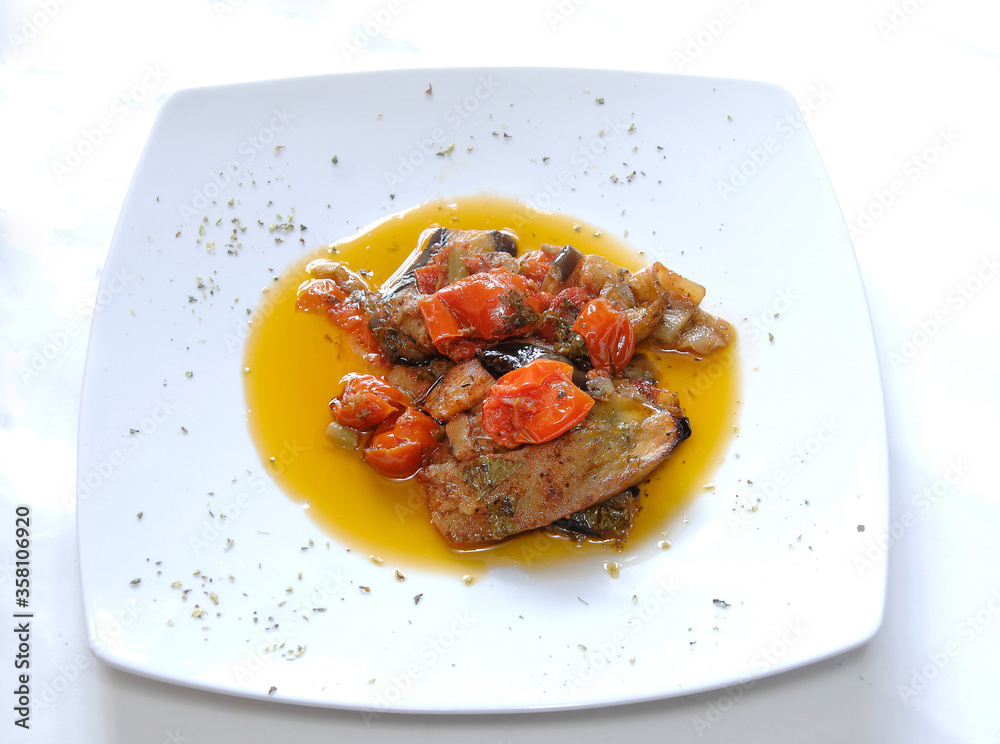 typical italian dish from the Campania region whit tomato and aubergines  isolated on the white background