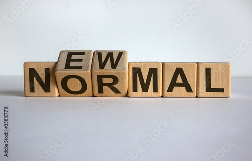 Concept words 'new normal' on cubes on a white table. Beautiful white background. Business concept.