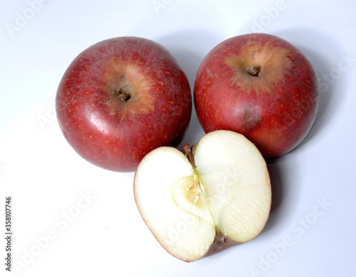 two small red apple called annurca e one opened from the Campania region isolated on white background photo