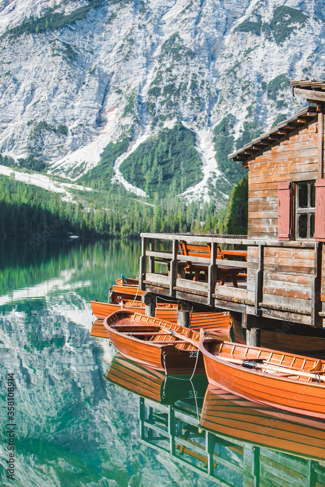 view of wooden dock boats station at braies lake in Italy