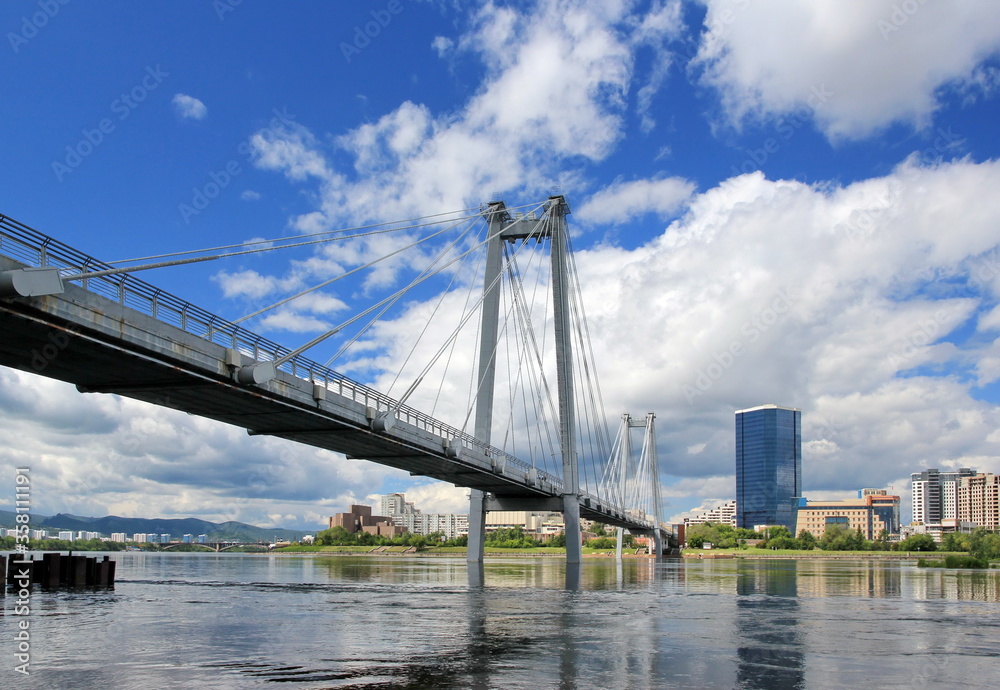 Vynogradovskiy Bridge across the Yenisei river. Sunny noon on the island of Tytyshev. Krasnoyarsk