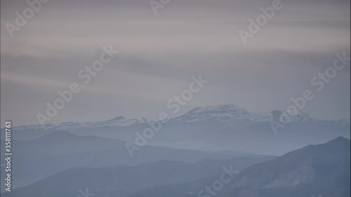 Clouds moving over Sierra Nevada mountain range in Spain. Nature landscape. Popular tourist destination. Time lapse

