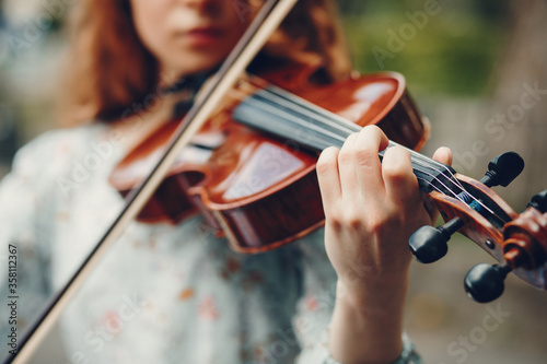 Girl in a summer park. Lady with a violin. Girl in a summer dress