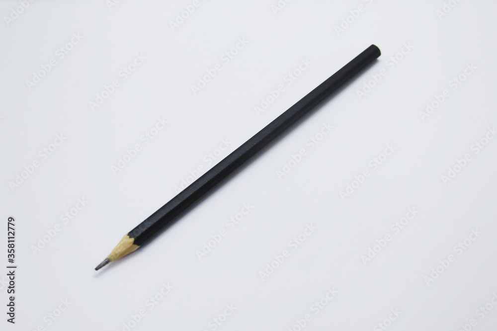 Black pencil, an instrument used to write, draw or doodle is cylindrical and wooden in shape with a graphite on the inside Black pencil, an instrument used to write, draw or doodle is cylindrical and wooden in shape with a graphite on the inside