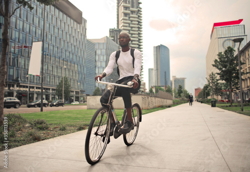 Fototapeta Naklejka Na Ścianę i Meble -  young man on a bicycle in the city
