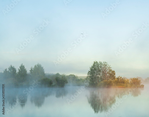 River before sunrise in the fog