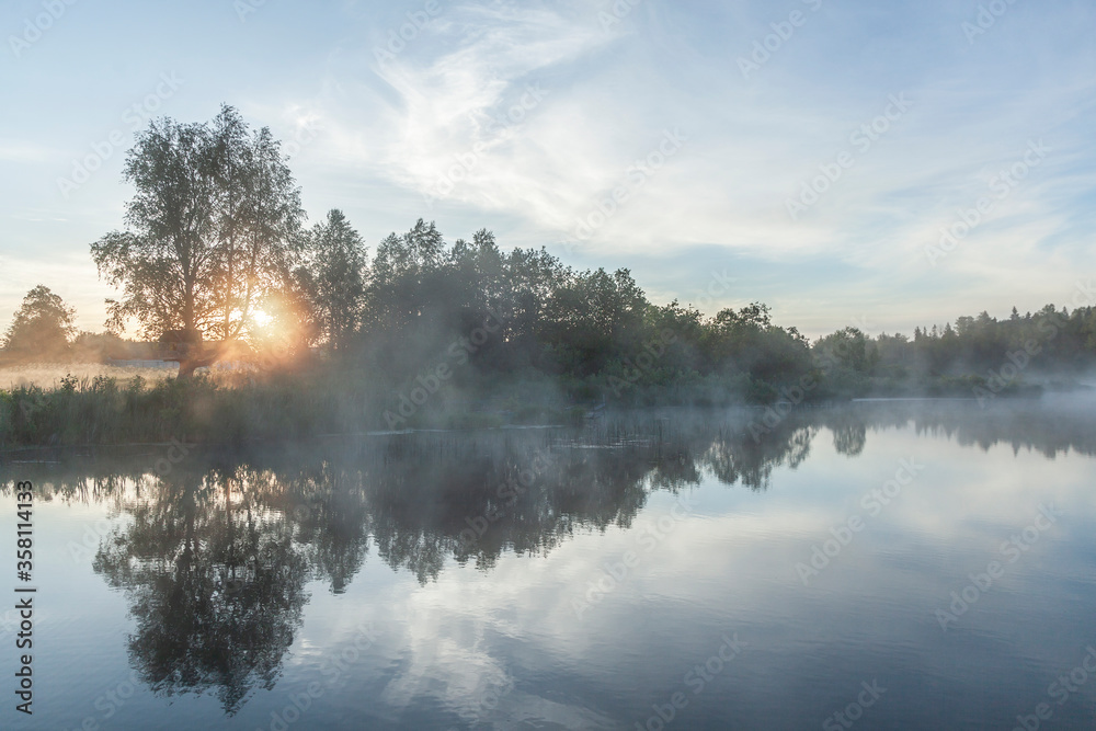 River before sunrise in the fog