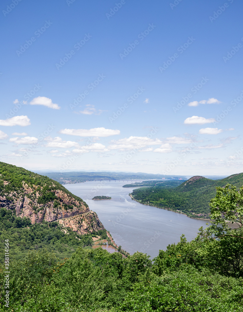 Beautiful valley and river landscape scene with blue sky and clouds portrait