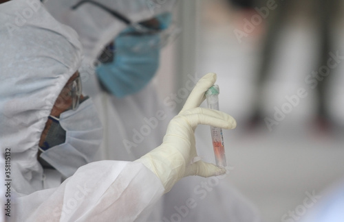 An Indian Lab technician wearing PPE kit while collecting swab sample for COVID-19 test, at a medical lab during ongoing COVID-19 lockdown. Government takes preventive measure against coronavirus