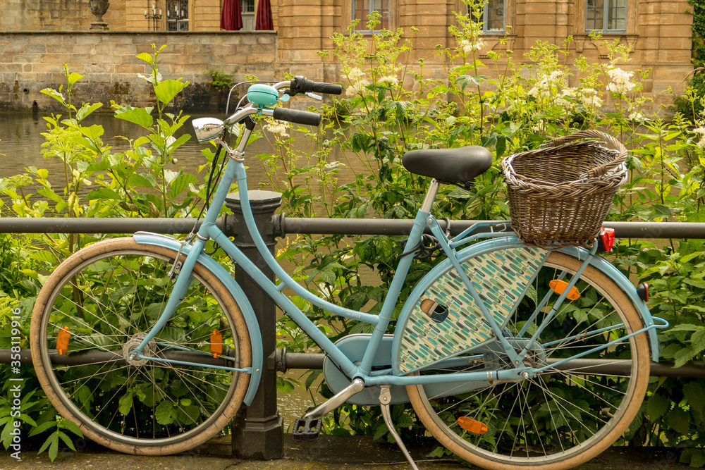 old blue bicycle with basket at the roadside old blue bicycle with basket at the roadside