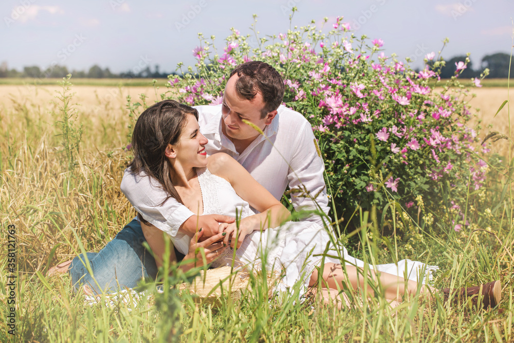 Couple near a flowering bush Couple near a flowering bush