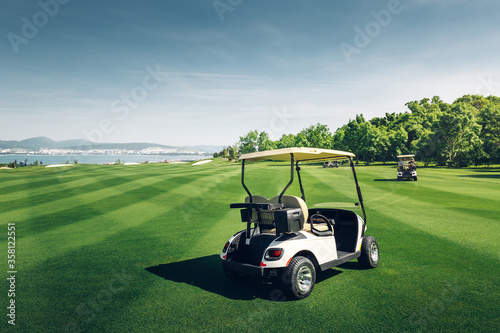 Golfcars Riding On Green Golf Course photo