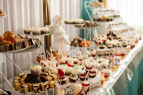 Sweet cakes at a wedding buffet. Catering