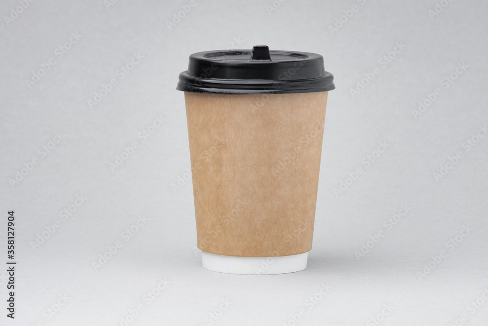 Paper coffee container on gray background. Takeaway drink cap container. Template of drink cup for your design. Free space for input text, image, and logo.