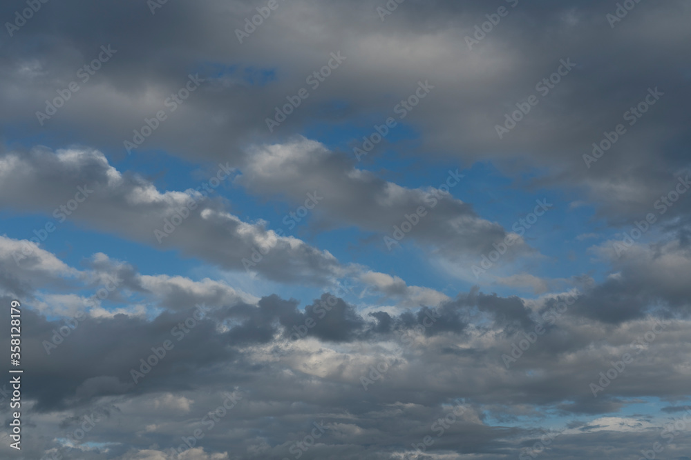 Dark thunderclouds on a blue sky. Texture for the background. Dark thunderclouds on a blue sky. Texture for the background.