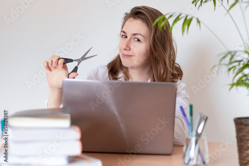Woman working on laptop at home office while drinling coffee. Web conection
