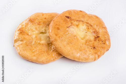 Delicious Georgian khachapuri - closed baked pie with homemade cheese isolated on white background