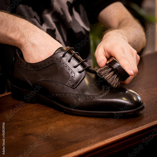 a man cleans shoes