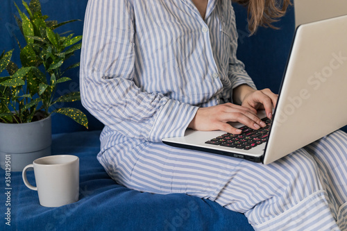 Woman using laptop personal computer on sofa. Work from home