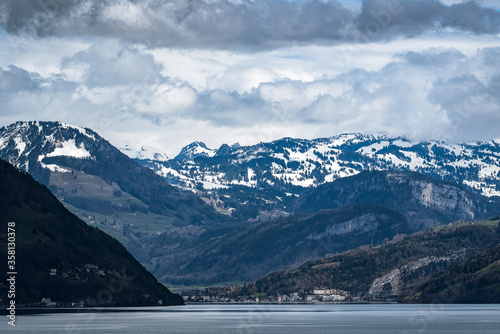 Suisse town dwarfed by surrounding mountains, suisse, alps, mountain, snow lake