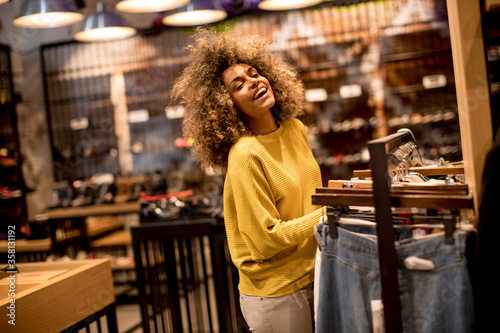 Young black woman with curly hair in shopping