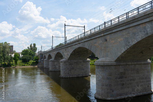 viaduct in the center of Prague on the Vltava river and blue sky with clouds 