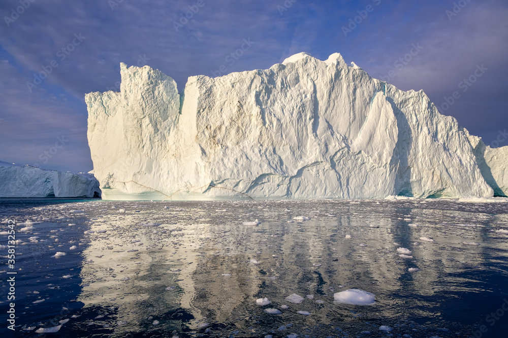 huge floating glaciers in the sea illuminated by the sun's rays