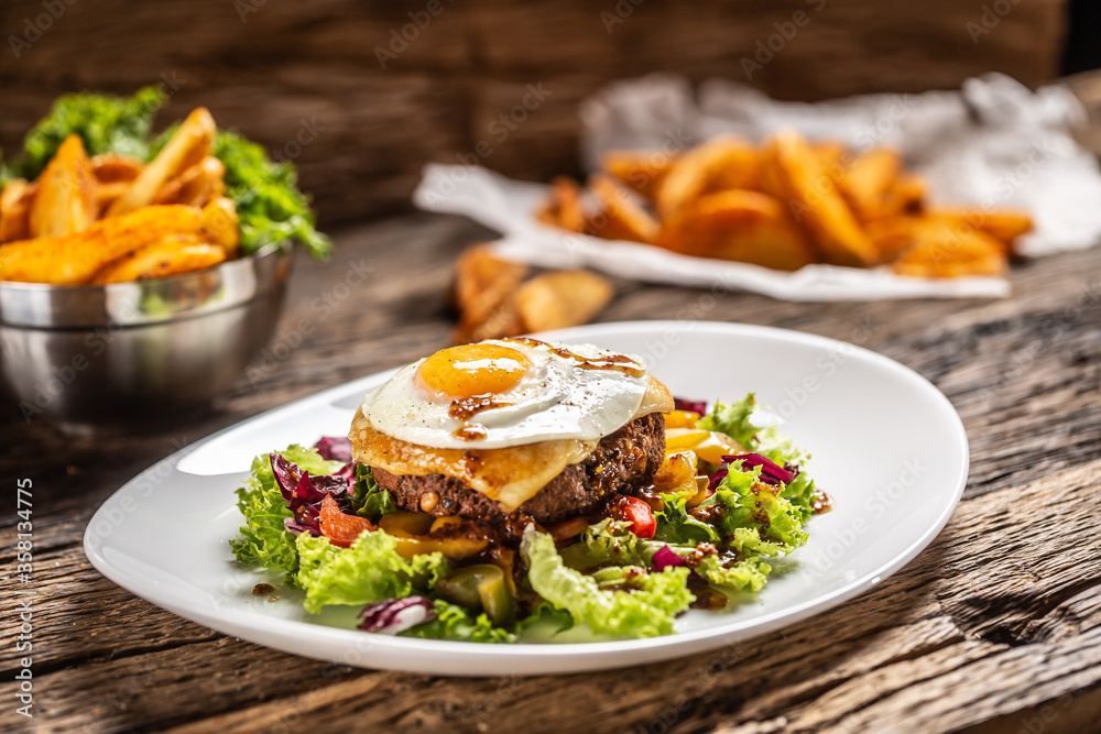 Vegetarian bean patty salad with melted cheese and sunny side up egg Vegetarian bean patty salad with melted cheese and sunny side up egg