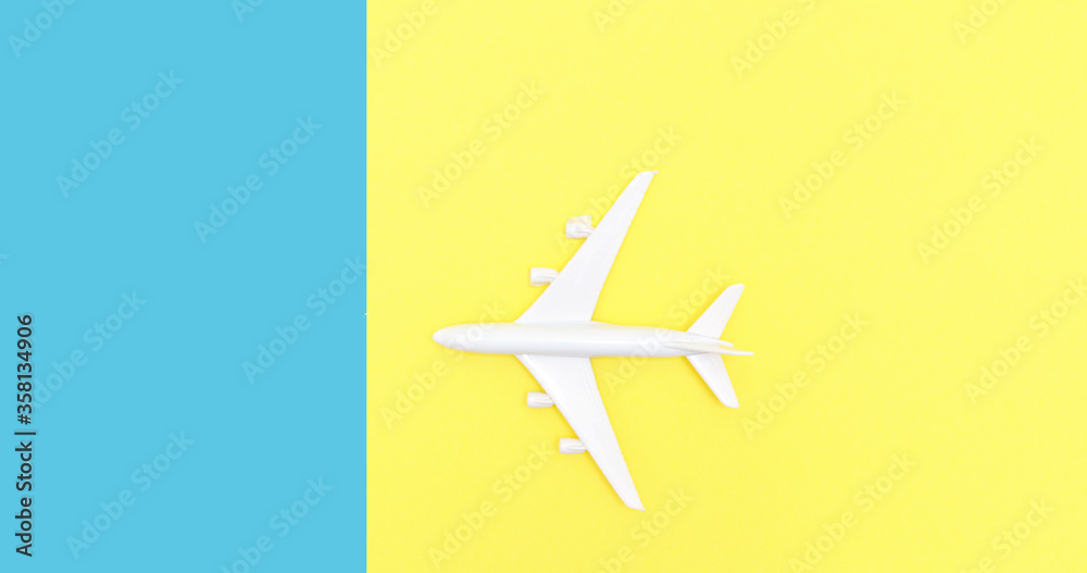 toy airplane on a double yellow-blue background. Summer vacation concept, travel. toy airplane on a double yellow-blue background. Summer vacation concept, travel.