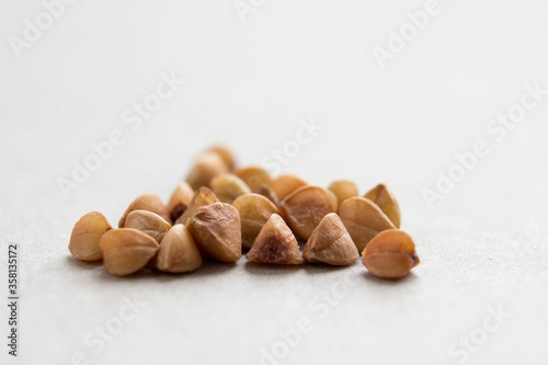 A handful of buckwheat on a table close-up. With place for your design photo