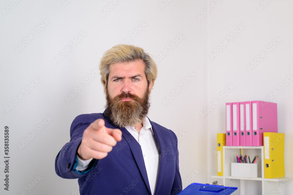 Serious businessman points to the camera. Business expert. Businessman working in office. Businessman with computer. Office worker. Advertising. Trade.