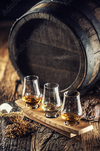 Fotografie, Obraz Glencairn tasting whiskey cups with wooden barrel, peat and barley next to them