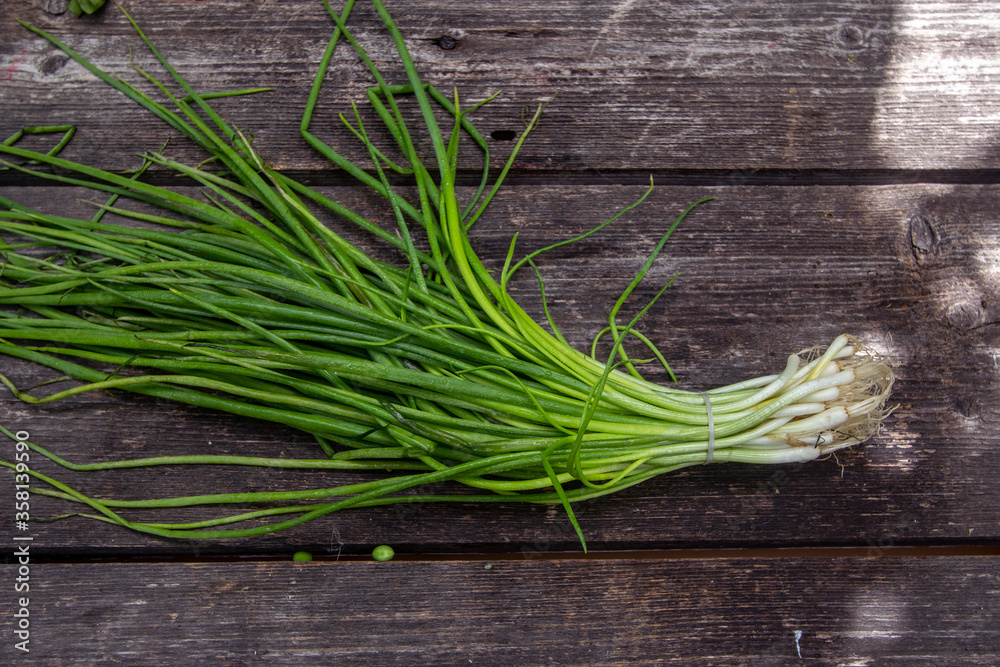 large bunch of shnit onion on a wooden background