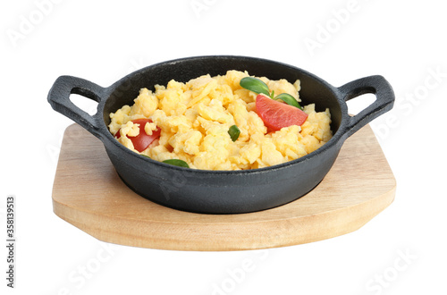 Tasty scrambled eggs with sprouts and cherry tomato in frying pan isolated on white