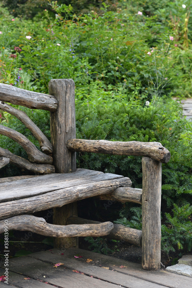 Wooden bench in beautiful park, in summer
