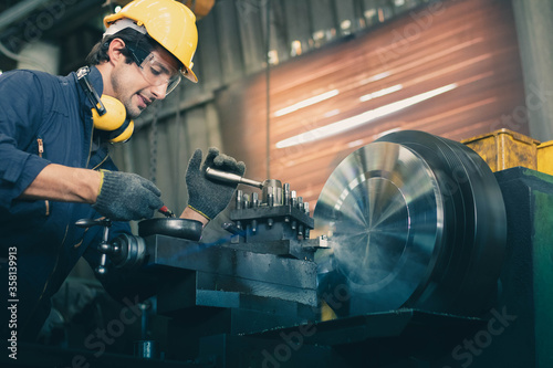 Worker work with machine in factory.