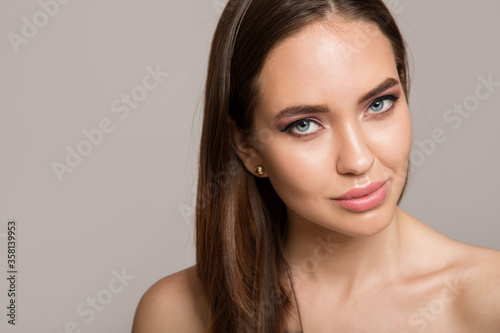 Portrait of a nude woman on a white background. open shoulders. Beautiful face