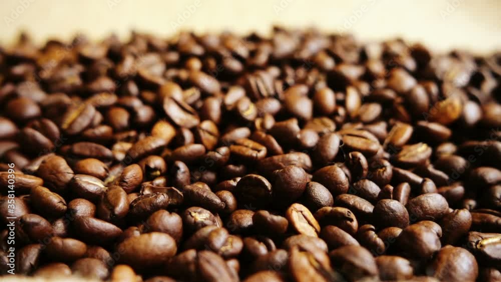 Coffee beans falling on the sack. Slow motion. Coffee beans falling on the sack. Slow motion.