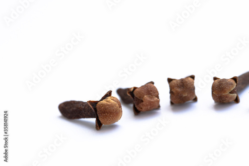 dry clove grains on white background