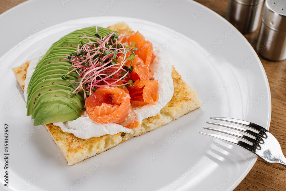 Tasty vegetarian sandwich with avocado and red fish Tasty vegetarian sandwich with avocado and red fish