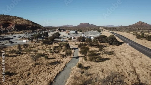 4K aerial drone video of African savanna hills, stone quarry near granite boulders range at B1 highway south of Windhoek in central highland Khomas Hochland of Namibia, southern Africa photo