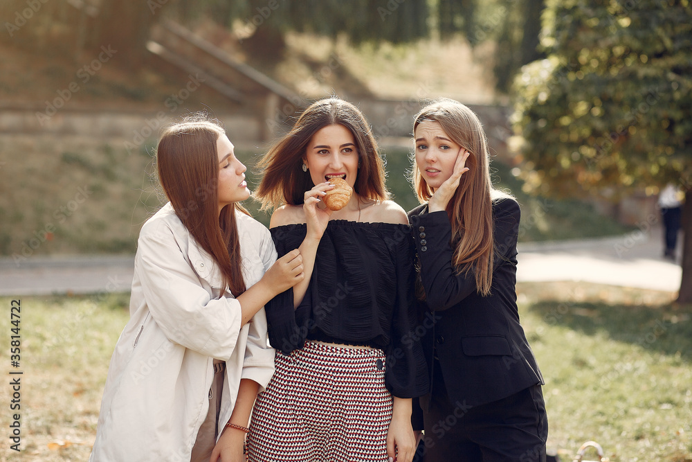 Students in a park. Girl in a park. Friends with a croissant.