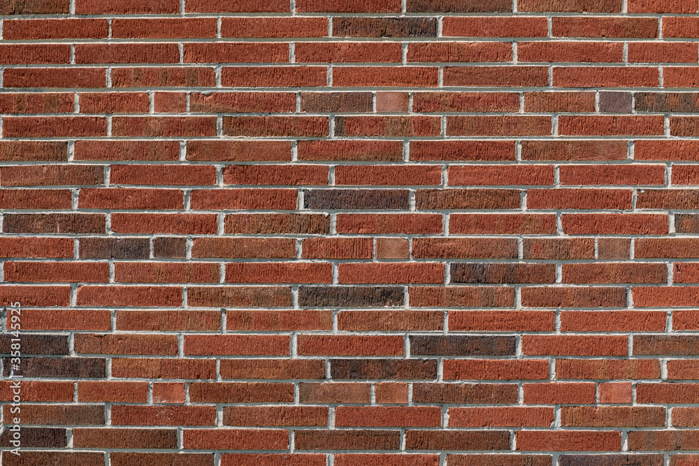 Long thin bricks in red and dark brown with a fine combed surface texture, creative copy space, horizontal aspect Long thin bricks in red and dark brown with a fine combed surface texture, creative copy space, horizontal aspect