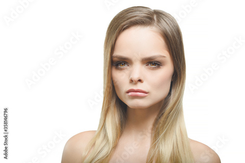A girl with an arrogant expression on a white background.