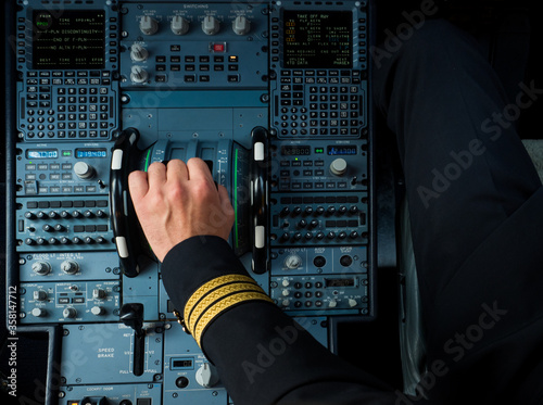 Captain hand accelerating on the throttle in commercial airplane