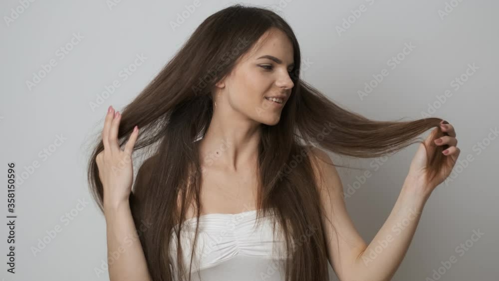 Very beautiful girl of Caucasian appearance with long black hair posing for the camera in the studio. active movement of life and dancing Very beautiful girl of Caucasian appearance with long black hair posing for the camera in the studio. active movement of life and dancing