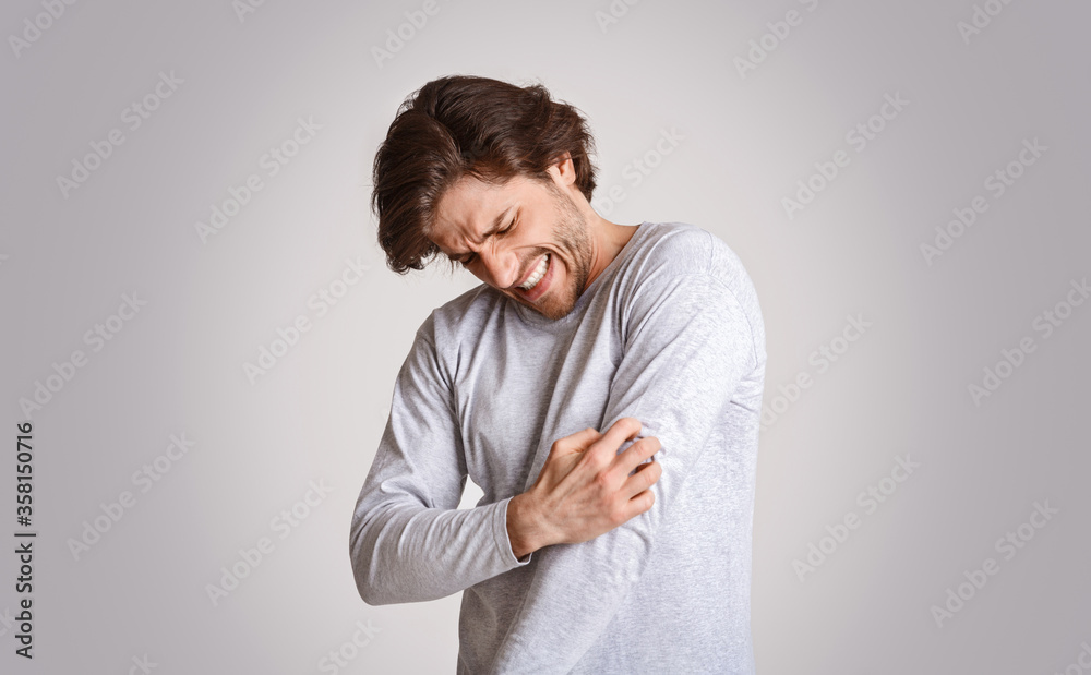 Allergic reaction. Man scratches his hand with force and suffers from itching Allergic reaction. Man scratches his hand with force and suffers from itching