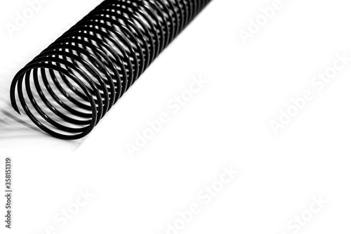 black plastic coil spring on white background
