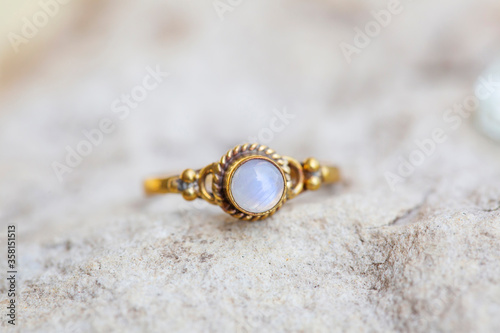 White metal silver ornamental ring with red moon stone mineral stone